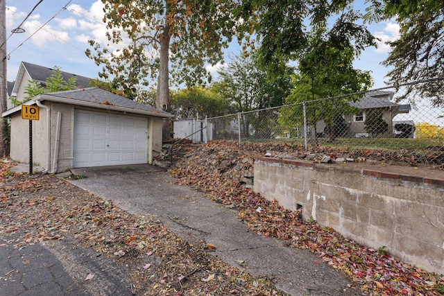 view of side of home with an outdoor structure and a garage