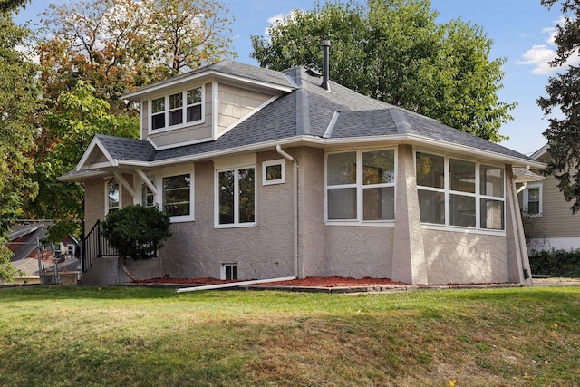 exterior space featuring a sunroom and a yard