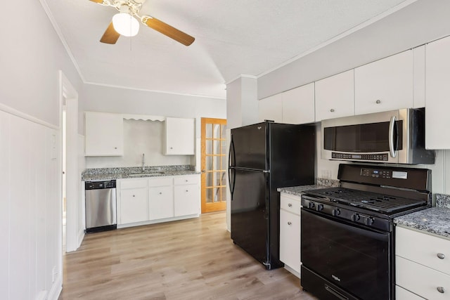 kitchen featuring black appliances, sink, light hardwood / wood-style floors, light stone counters, and white cabinetry