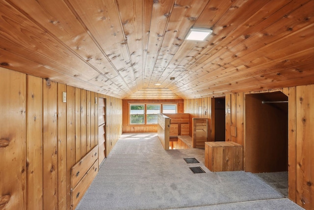 additional living space with wooden walls, carpet, wooden ceiling, and vaulted ceiling