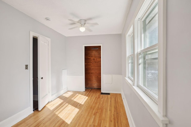 spare room featuring ceiling fan and light wood-type flooring