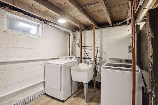 laundry area with washer and dryer and light hardwood / wood-style flooring