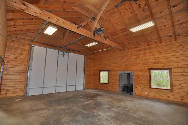 31071 State 34, Akeley Twp, MN 56433 - garage featuring wooden walls, a garage door opener, and a wood stove