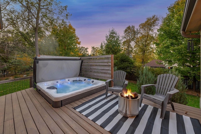 deck at dusk with a covered hot tub