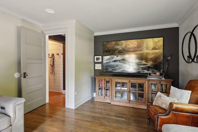 sitting room with crown molding and dark wood-type flooring