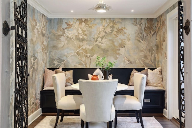 dining area with crown molding, breakfast area, and dark hardwood / wood-style floors