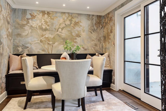 dining area featuring hardwood / wood-style floors and ornamental molding