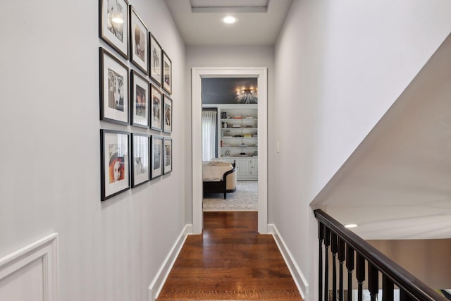 corridor with dark hardwood / wood-style flooring