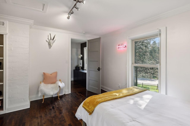 bedroom with multiple windows, crown molding, dark hardwood / wood-style flooring, and track lighting