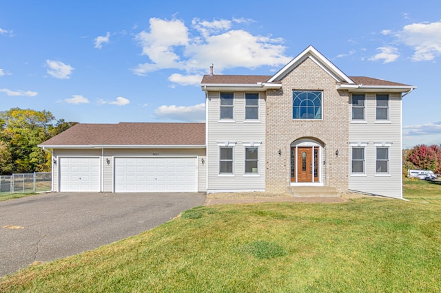 view of front facade with a front yard and a garage