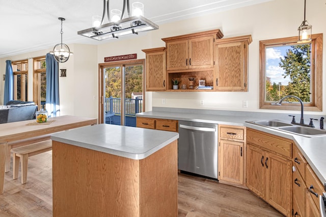 kitchen featuring dishwasher, a center island, decorative light fixtures, and a wealth of natural light