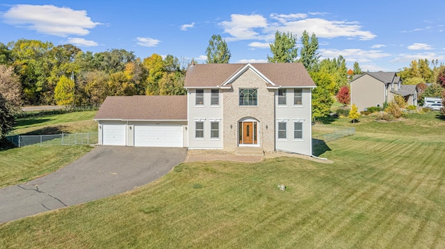 view of front facade featuring a front lawn and a garage