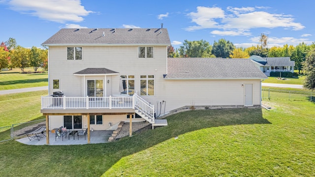 back of house with a patio, a wooden deck, and a lawn