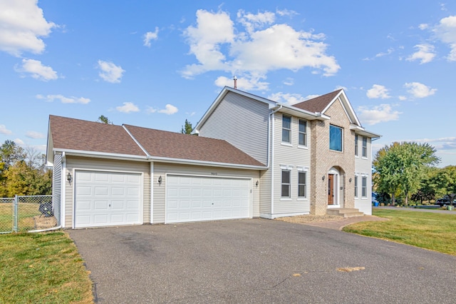 view of front of property featuring a front lawn and a garage