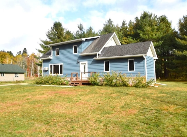 rear view of property with a yard and a wooden deck