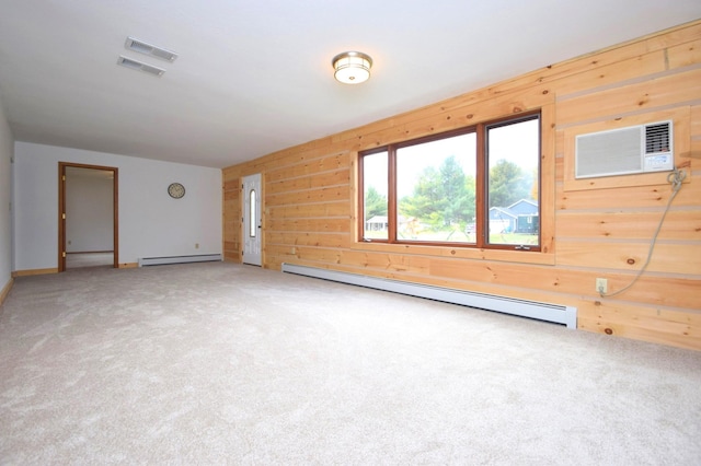 spare room with a baseboard radiator, wood walls, and a wall mounted AC