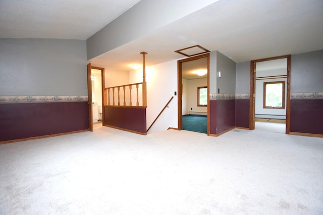 empty room featuring carpet floors and baseboard heating