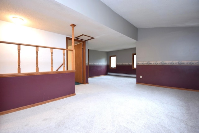 unfurnished room with a wainscoted wall, a baseboard heating unit, baseboards, and carpet floors