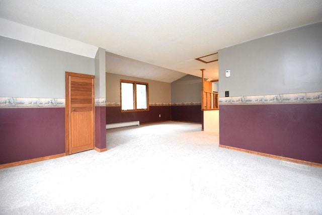 interior space featuring a baseboard radiator, lofted ceiling, carpet, and wainscoting