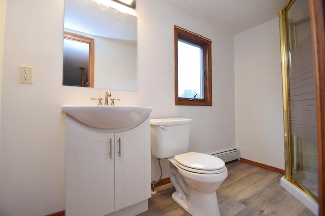 full bath with baseboard heating, wood finished floors, vanity, and toilet