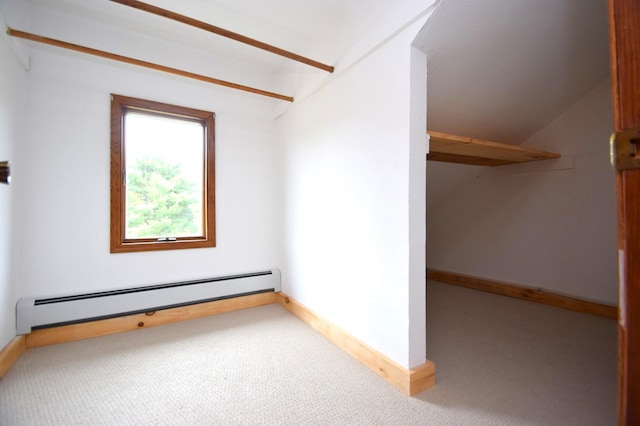 carpeted spare room with baseboard heating and baseboards