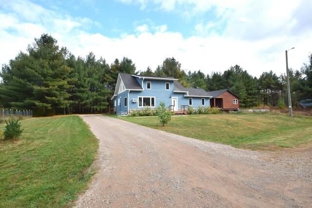 view of front of property with driveway and a front lawn