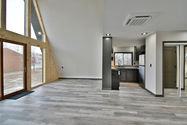 unfurnished living room featuring light hardwood / wood-style floors and sink