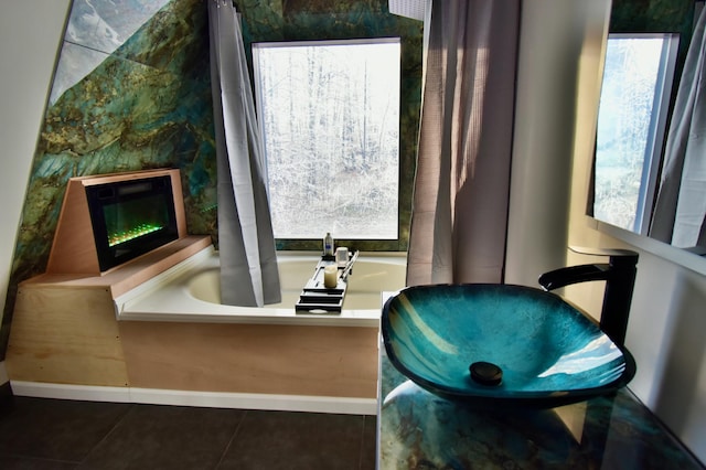 bathroom with a bathing tub and tile patterned floors