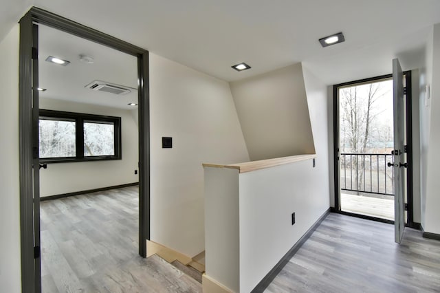 hallway with light hardwood / wood-style flooring