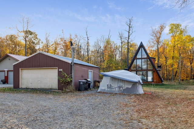 view of side of property with an outbuilding and a garage