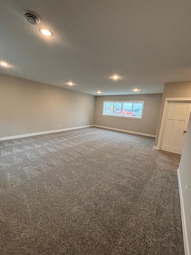 basement with dark colored carpet and a textured ceiling