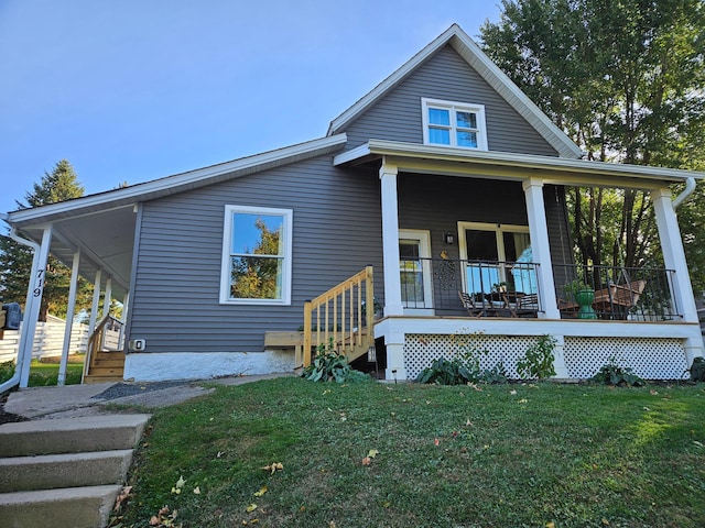 back of house with a yard and covered porch