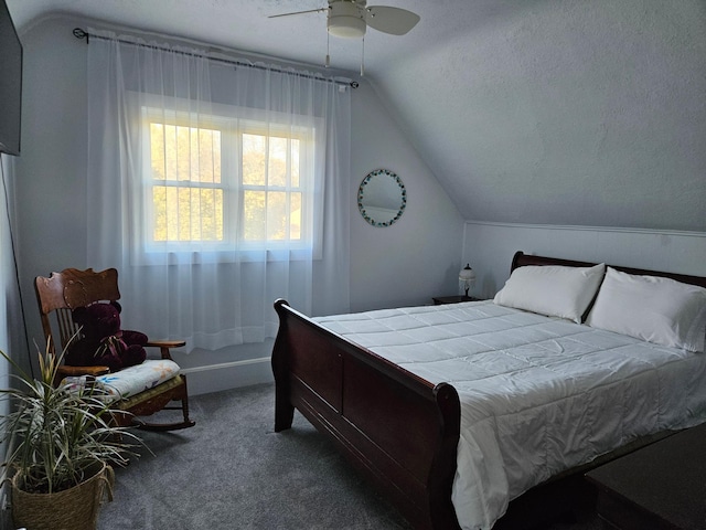 bedroom with lofted ceiling, a textured ceiling, carpet floors, and ceiling fan