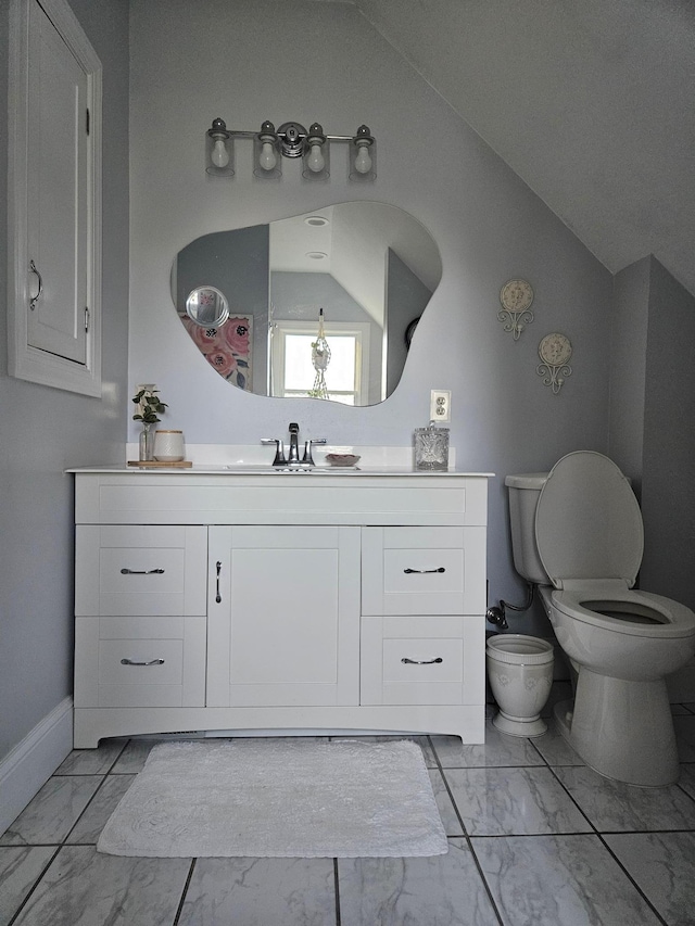 bathroom featuring toilet and vanity