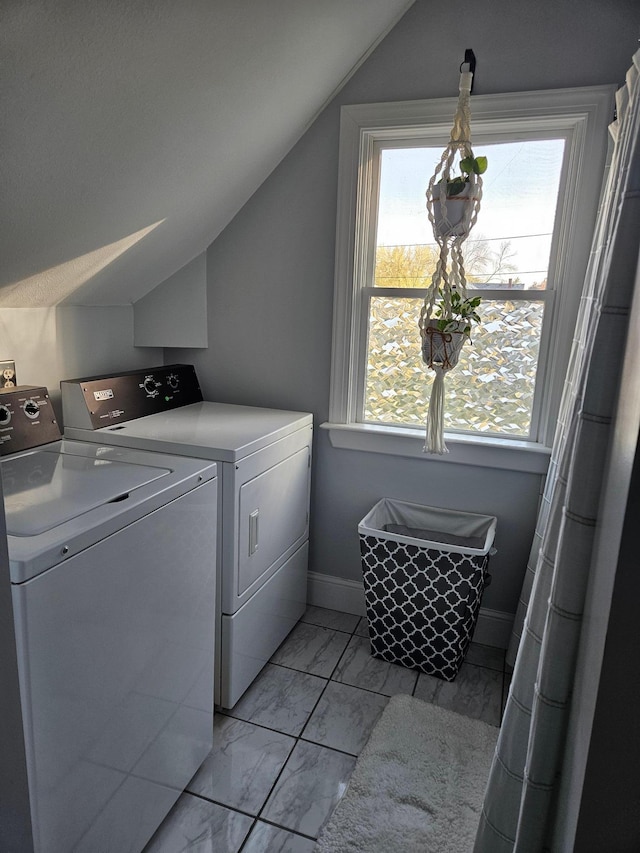 clothes washing area with separate washer and dryer