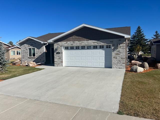 ranch-style house with a front lawn and a garage