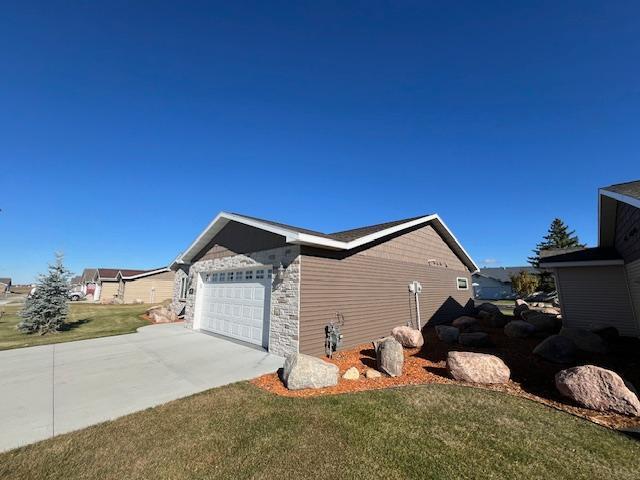 view of property exterior with a lawn and a garage