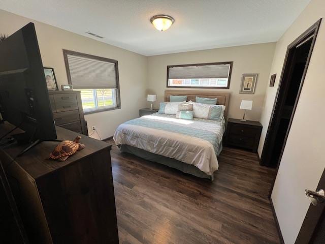 bedroom with dark wood-type flooring