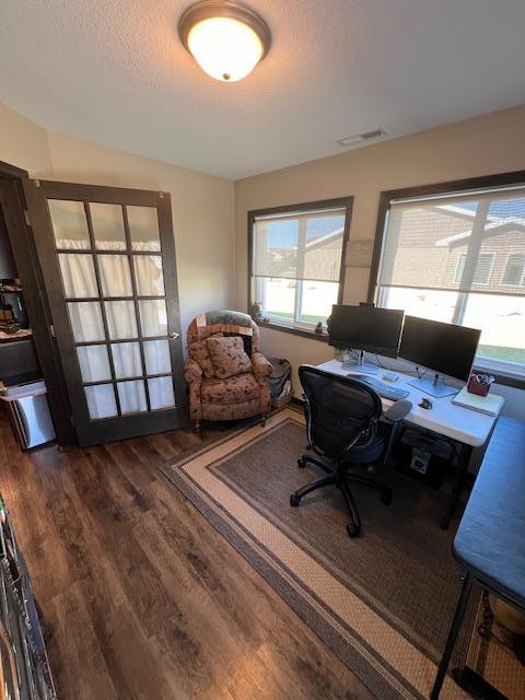 office space featuring a textured ceiling and dark hardwood / wood-style flooring