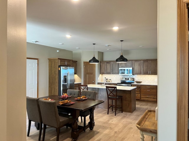 dining space with light hardwood / wood-style flooring and sink