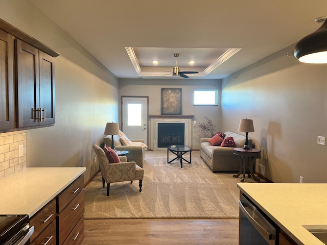 3106 Bassett Dr, Mankato, MN 56001 - living area with a fireplace, ceiling fan, a tray ceiling, and light wood finished floors