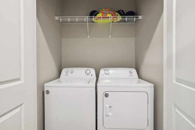 washroom featuring laundry area and washing machine and dryer