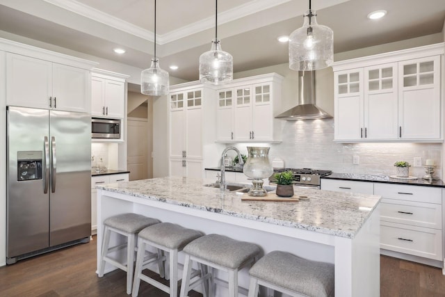kitchen featuring wall chimney exhaust hood, crown molding, appliances with stainless steel finishes, decorative backsplash, and dark wood-style floors