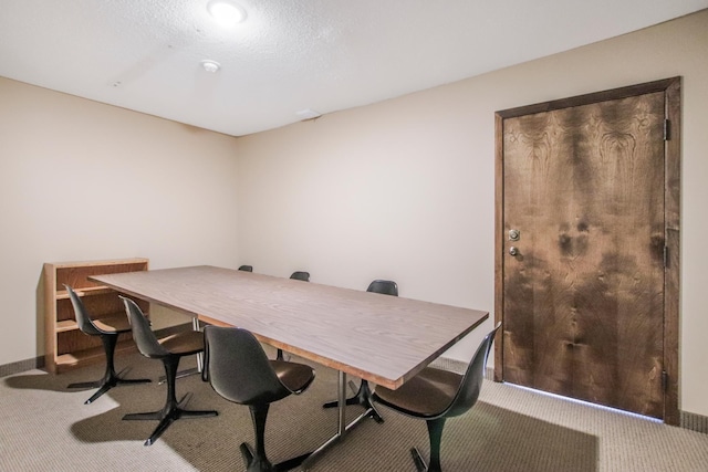 home office featuring a textured ceiling and carpet flooring