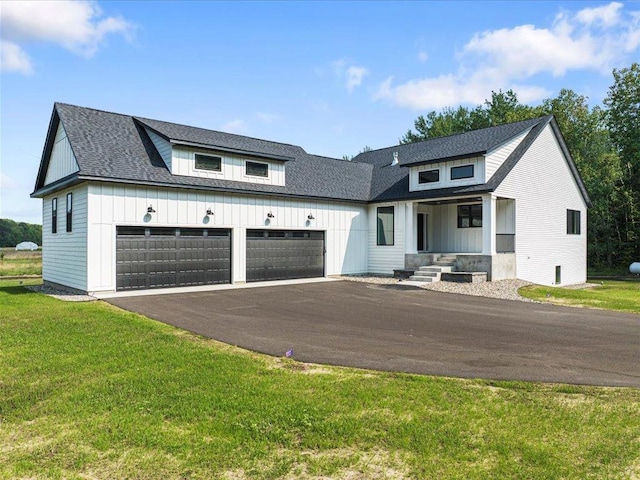 modern farmhouse with a front lawn and a garage