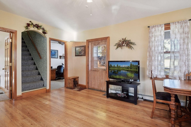 foyer entrance featuring ceiling fan and light wood-type flooring