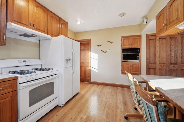 kitchen with light hardwood / wood-style flooring and white gas stove