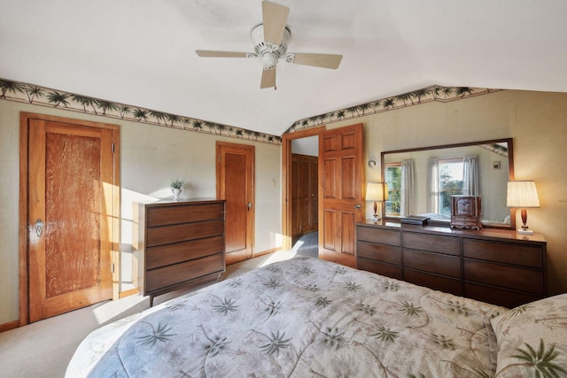 carpeted bedroom featuring ceiling fan and vaulted ceiling