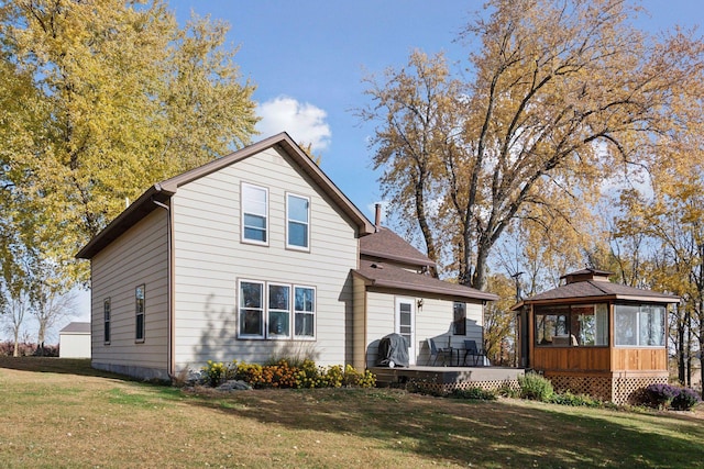 view of front of home with a front lawn and a sunroom