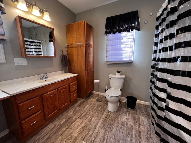 bathroom featuring hardwood / wood-style floors, vanity, and toilet